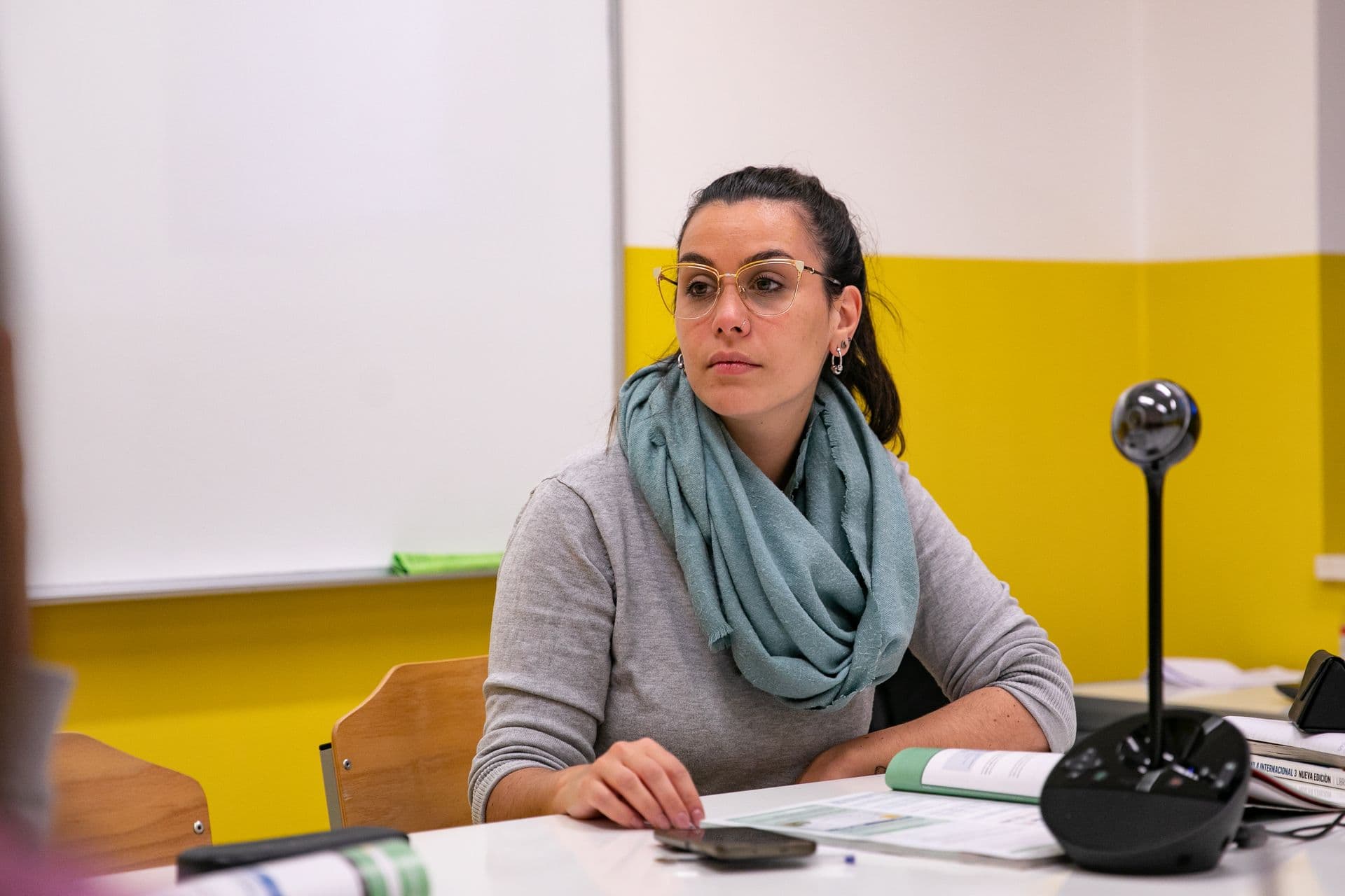 A teacher talking with learners at a table