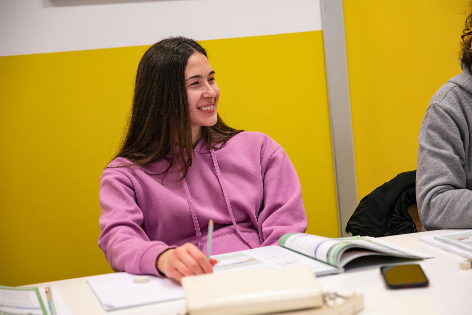 A university student smiling in class
